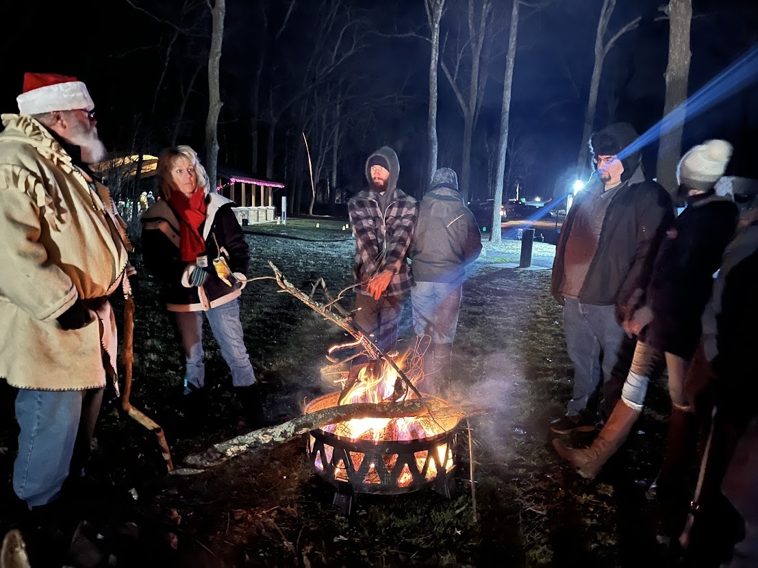 Park guests around a fire pit.